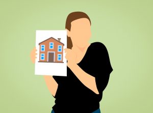 woman holding a picture of a house